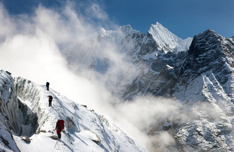 group of climbers on mountains montage to mounts Kangtega and Thamserku Everest area Khumbu valley Nepal