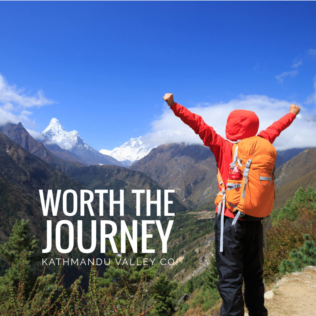 Hiker reaching out in excitement at reaching a view of Ama Dablam peak in Nepal.