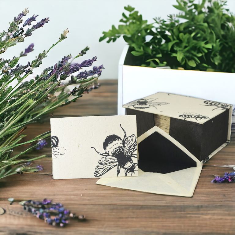 Bees Cherish Cards with black-lined envelopes on a wooden table beside lavender