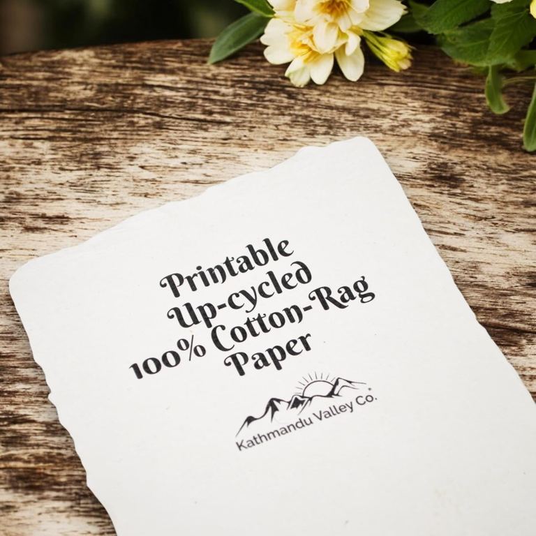 A white cotton-rag sheet printed with the words “Printable Up-cycled 100% Cotton-Rag Paper” on weathered wood