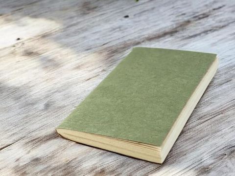 The Pocket Sage Nepali Companion notebook on a weathered wooden table