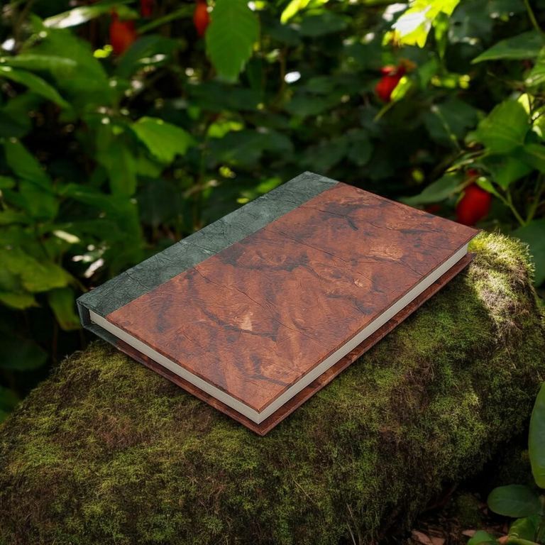 The Forest Bliss Nepali Eco journal on a mossy rock among leaves and red berries