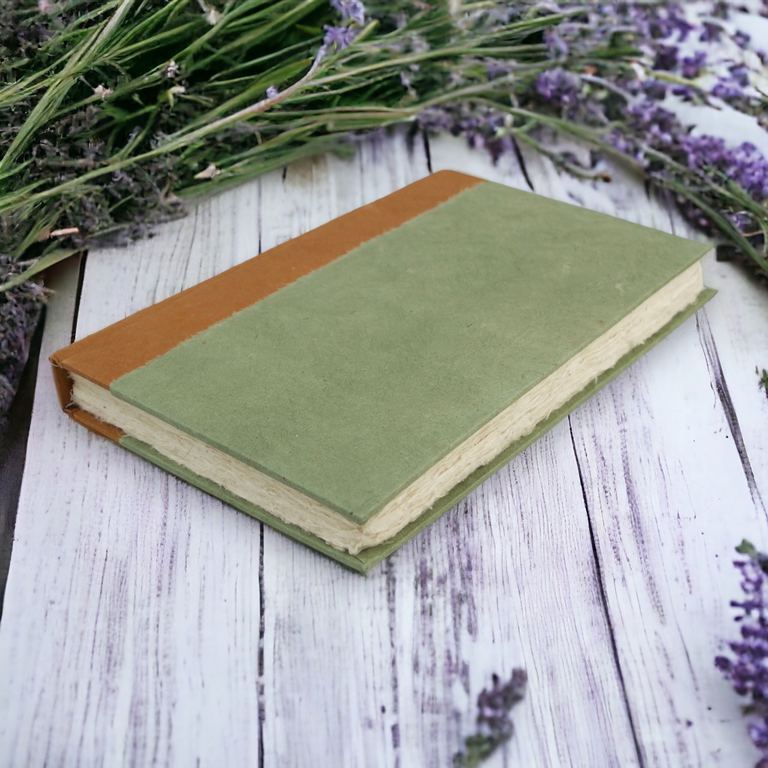 The 6 × 9 Sage Nepali Namaste journal on whitewashed boards among sprigs of lavender